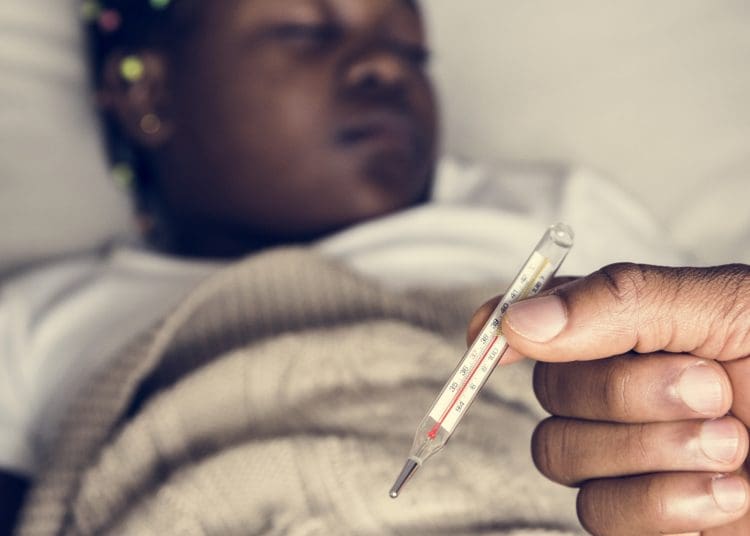 cost of living crisis a girl with someone holding a thermometer