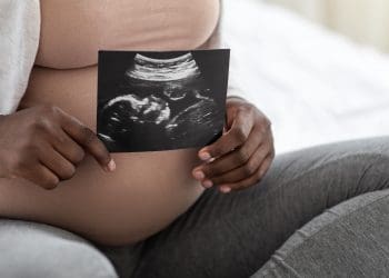 MBRRACE-UK a pregnant woman holding a scan