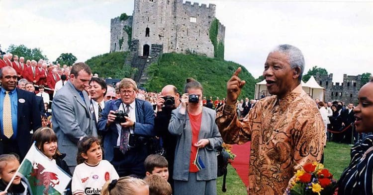 Nelson Mandela in front of a castle in Wales