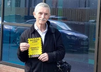 Welsh language campaigner holding a parking fine