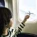 boy playing with model plane on a plane aerotoxic syndrome