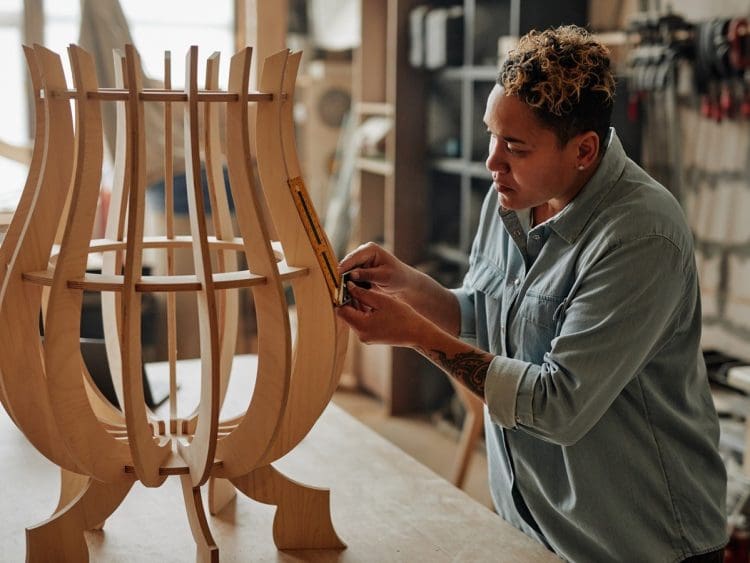 A woman crafting bespoke furniture design