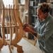 A woman crafting bespoke furniture design