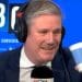 Starmer drinking a drink and smirking