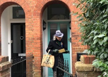 A Just Stop Oil supporter posting a letter through Keir Starmer letterbox Labour