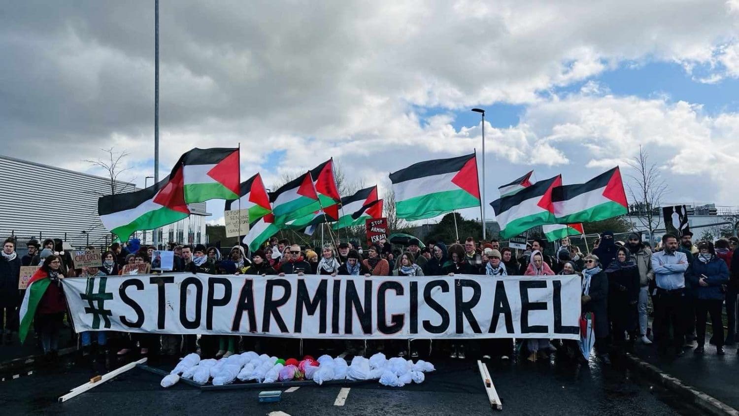 A banner reading Stop Arming Israel