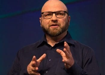 Andrew Feinstein photographed mid-speech with his hands gesturing, arsenal