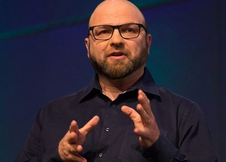 Andrew Feinstein photographed mid-speech with his hands gesturing, arsenal