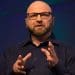 Andrew Feinstein photographed mid-speech with his hands gesturing, arsenal