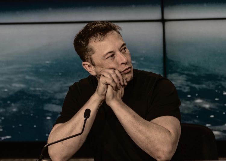 Elon Musk at a press conference Tesla