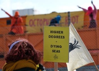 Extinction Rebellion North Sea protest placard that reads higher degrees equals warming seas