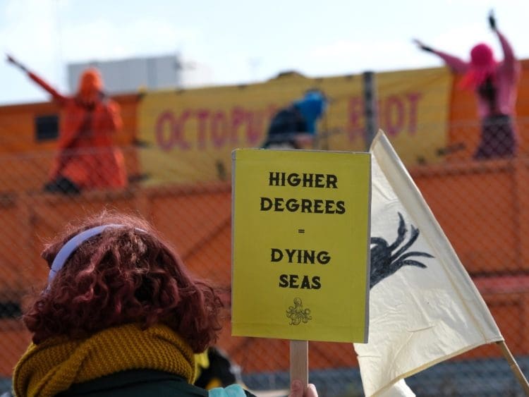 Extinction Rebellion North Sea protest placard that reads higher degrees equals warming seas