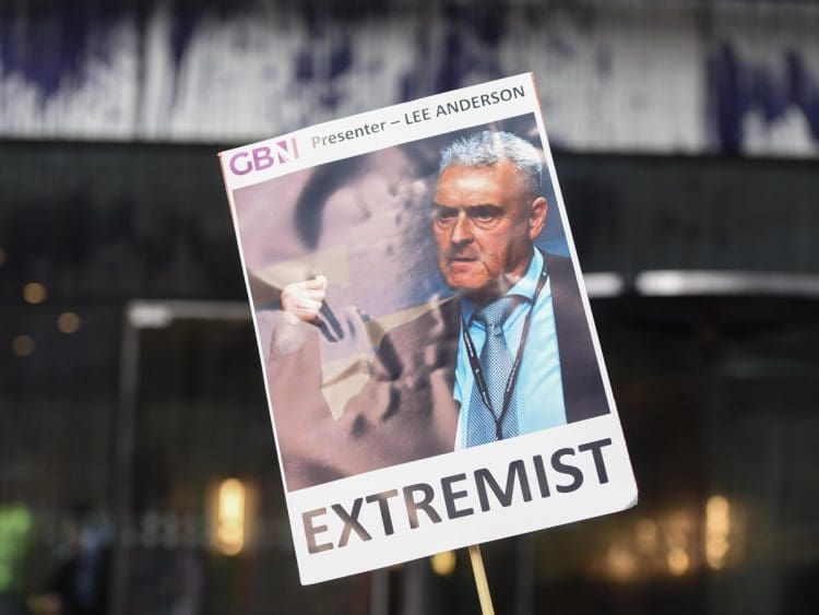 GB News a placard with a picture of Lee Anderson that says extremist