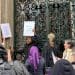 Garrick Club with people protesting outside