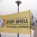 Greenpeace protesters with a stop Shell banner in the arctic one dressed as a polar bear net zero