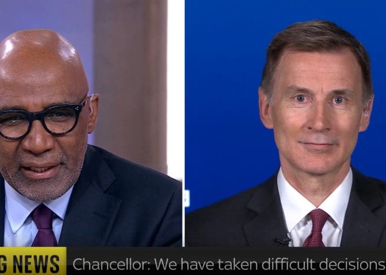 Jeremy Hunt smirking speaking to Trevor Phillips