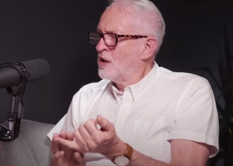 Jeremy Corbyn in front of a mic counting with his fingers 5 demands Peace and Justice Project Labour