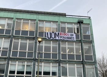 Manchester University a sign hanging from a window that reads UOM blood on your hands Israel