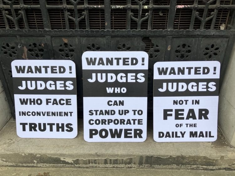 Protest placards over Judge Reid