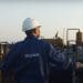 Azerbaijan state fossil fuel company SOCAR employee looks out across an industrial oil and gas site.