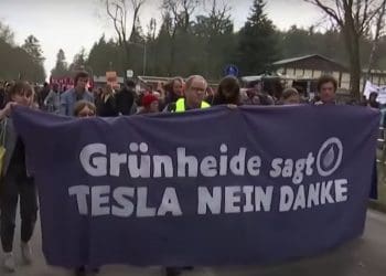 Protesters in Germany march with a banner that reads: "GrunHeide sagt TESLA NEIN DANKE" which translates to "Grunheide says TESLA NO THANKS" Musk