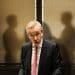 Michael Gove in front of two shadowy figures leaseholders