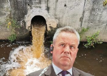 Thames Water boss Chris Weston looking up at a drain pouring out shit