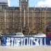 parliament protest with a banner that says tory cuts kill. fuel poverty