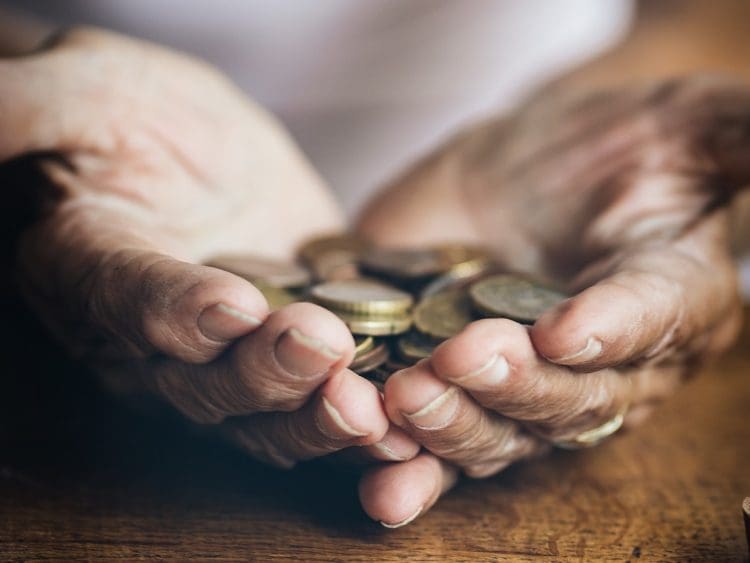 elderley hands holding coins homeowners care home costs