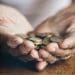 elderley hands holding coins homeowners care home costs