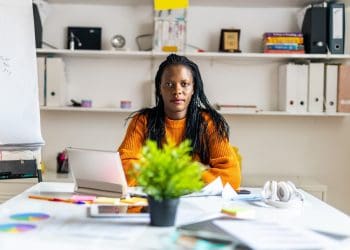 working class women pay a woman sitting at a desk
