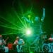 British Paraorchestra disabled musicians with a disabled dancer against a green light