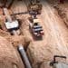 Construction workers lay an oil pipeline EACOP