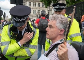 Neil Goodwin with two cops outside parliament
