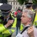 Neil Goodwin with two cops outside parliament