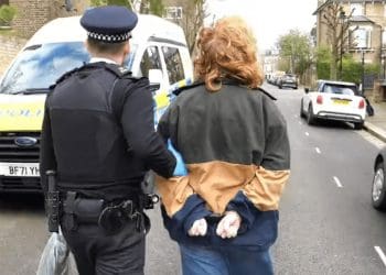 Activist being led away by a cop Starmer