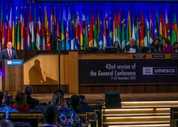 Speaker at the podium at a UNESCO World Heritage Day meeting in 2023.