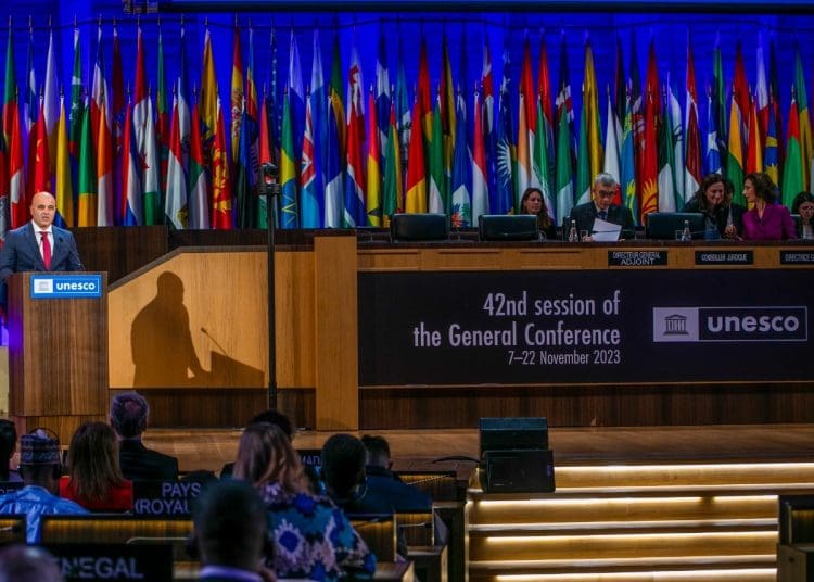 Speaker at the podium at a UNESCO World Heritage Day meeting in 2023.