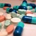 Different pills manufactured by pharmaceutical companies.