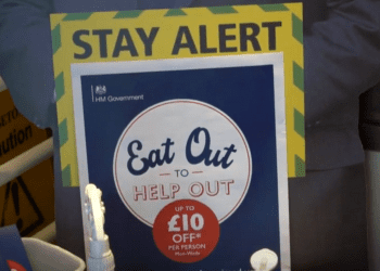 Eat out to help out poster, with a sign behind saying "stay alert".