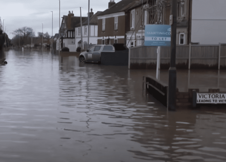 Flooding down a UK residential street climate insurance weather