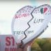 Heart-shaped placard reads: "Women Life Freedom". Iran's executions Iran