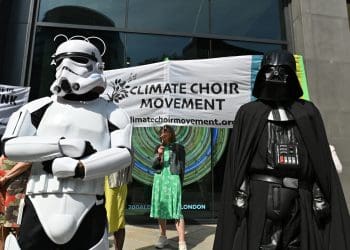 Climate Choir protesters stand alongside Darth Vader and a Storm Trooper outside Standard Chartered's AGM.