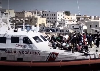 Coastguard ship in a port with refugees EU migration pact
