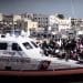 Coastguard ship in a port with refugees EU migration pact