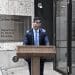 DWP Caxton House Rishi Sunak outside in the rain general election