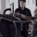 Lady uses EGYM equipment with an EGYM trainer behind long Covid exercise programme Northamptonshire