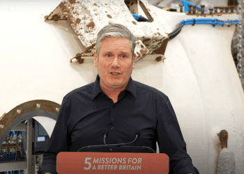 Starmer announcing Great British Energy stood over a podium that reads: 5 missions for a better Britain Labour donations fossil fuels