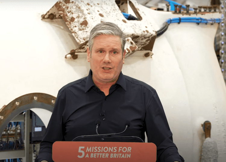 Starmer announcing Great British Energy stood over a podium that reads: 5 missions for a better Britain Labour donations fossil fuels