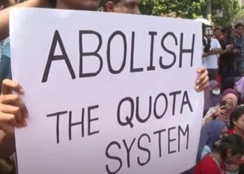 Bangladesh protesters hold a placard that reads: "Abolish the quota system"
